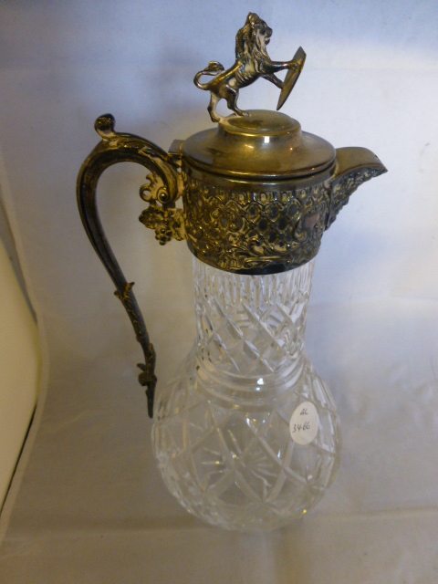 Crystal claret jug with silver plated ornate lid and handle