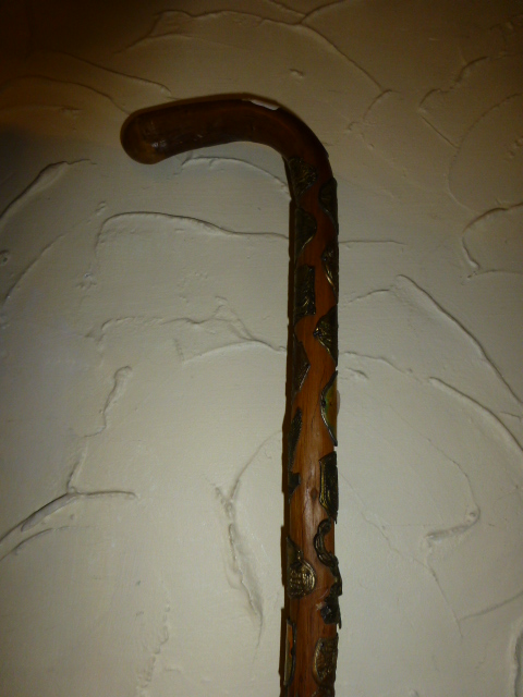 Walking stick with large quantity of badges