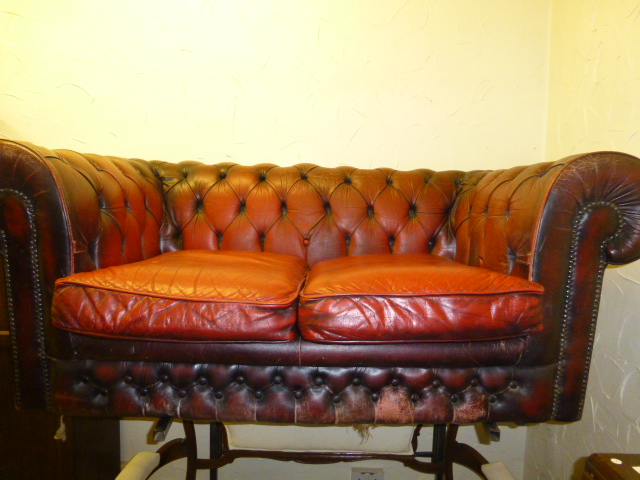 Red leather two seater Chesterfield