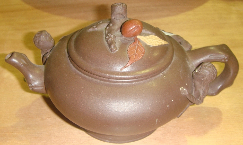 Yixing type teapot with character mark underneath decorated with mythical creatures and Japanese