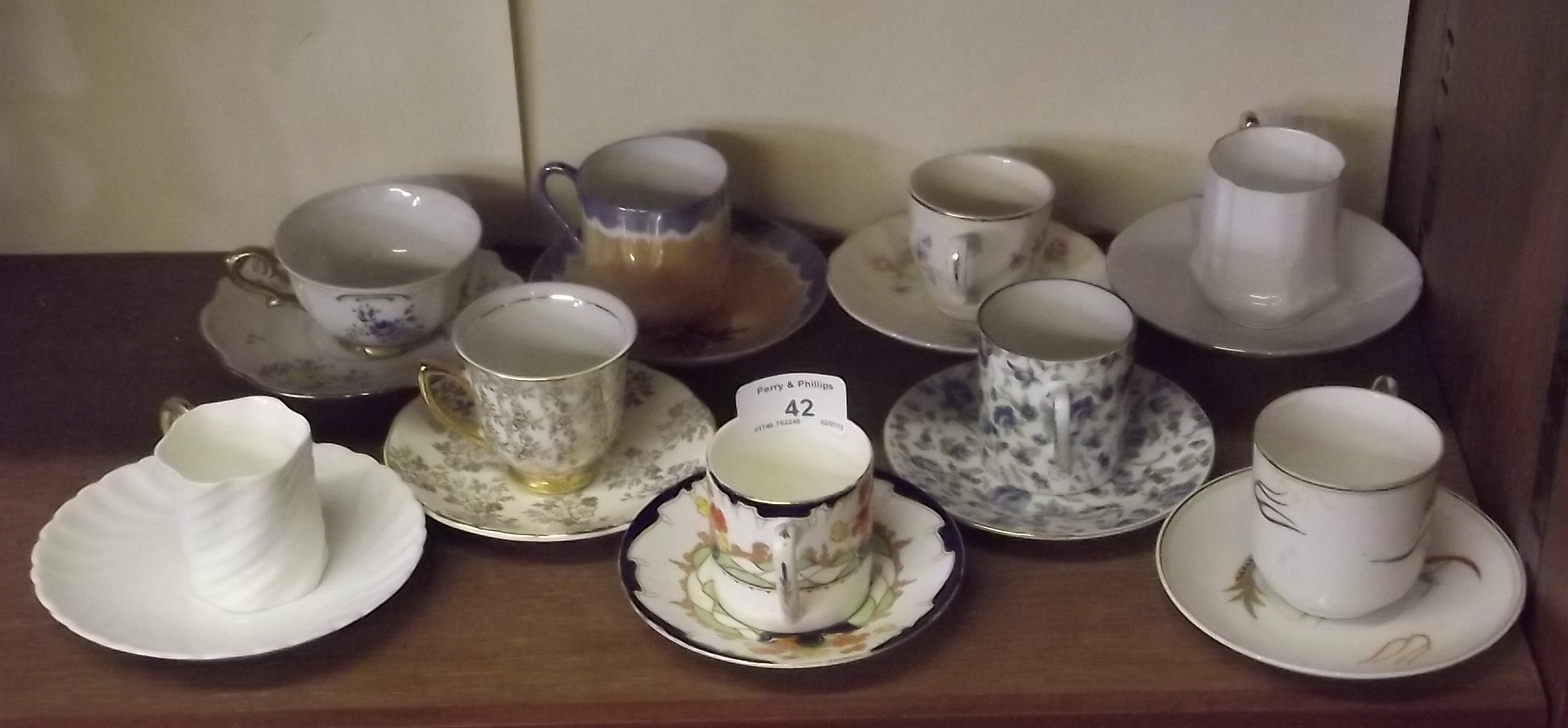 Nine Decorative Cups and Saucers