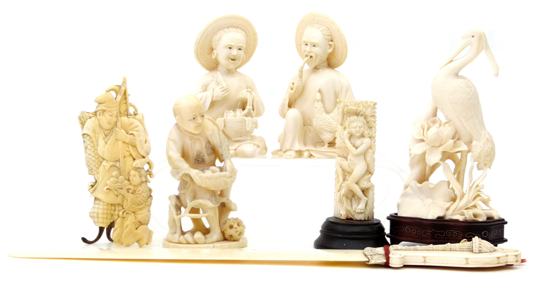 Pair of Chinese ivory seated figures of a farmer and his wife with their wares, incised four