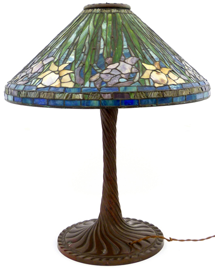 Tiffany style electric table lamp with a leaded coloured glass shade of leaves and flowers on a