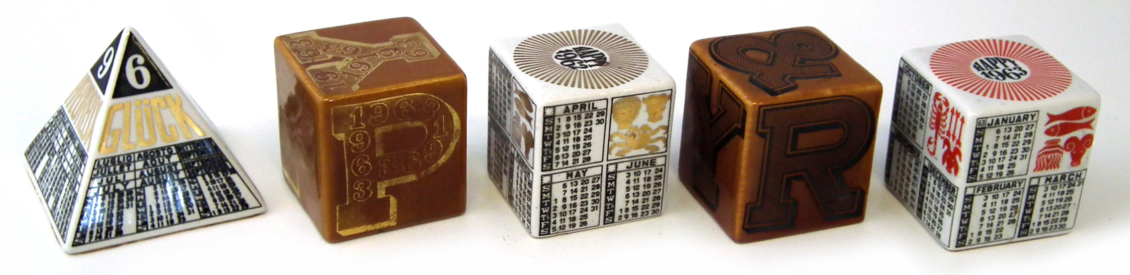 Two Fornasetti calendar cubes for the years 1962 and 1963, also a 1962 pyramid, a Happy 1963 year