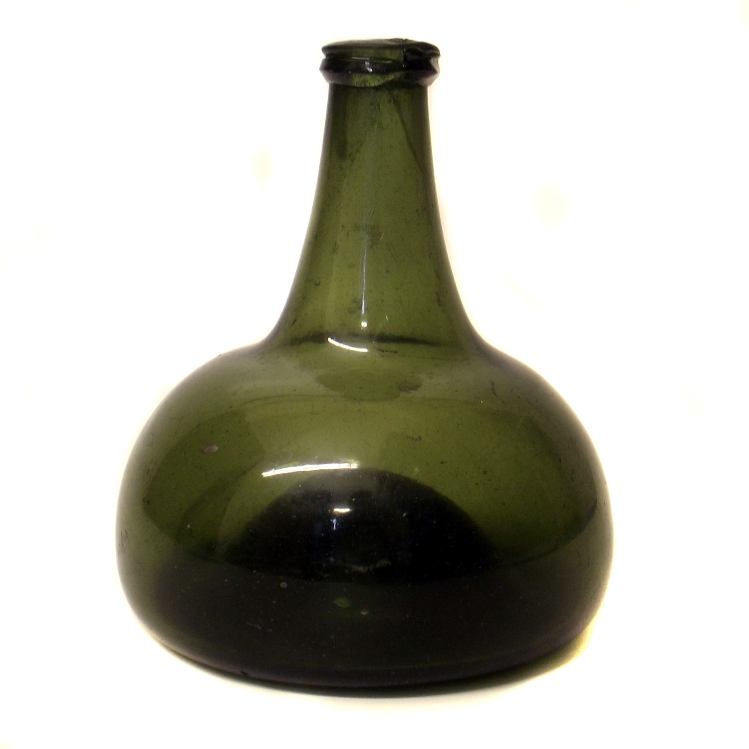 An early 18th century glass wine bottle of compressed mallet form.