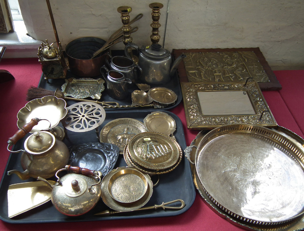Collection of brass including a lantern clock, seven graduated saucepans, candlesticks, companion