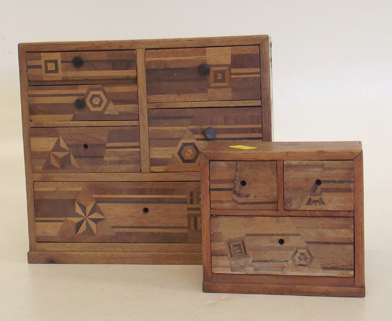 Two Japanese parquetry miniature table top chests of drawers.