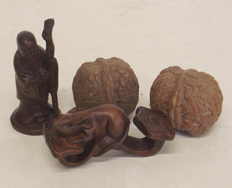 Two carved Netsukes and two walnuts.