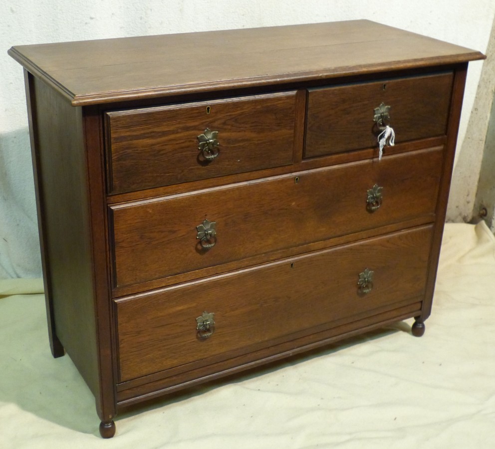 A 1920`s Oak Straight Front Chest of Drawers having 2 short, 2 long graduated drawers with drop