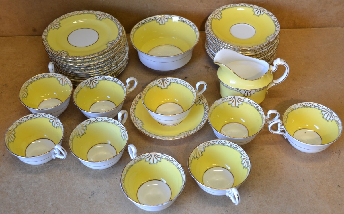 An Anysley Part Tea Service on yellow ground having gilt decoration comprising milk jug, sugar bowl,