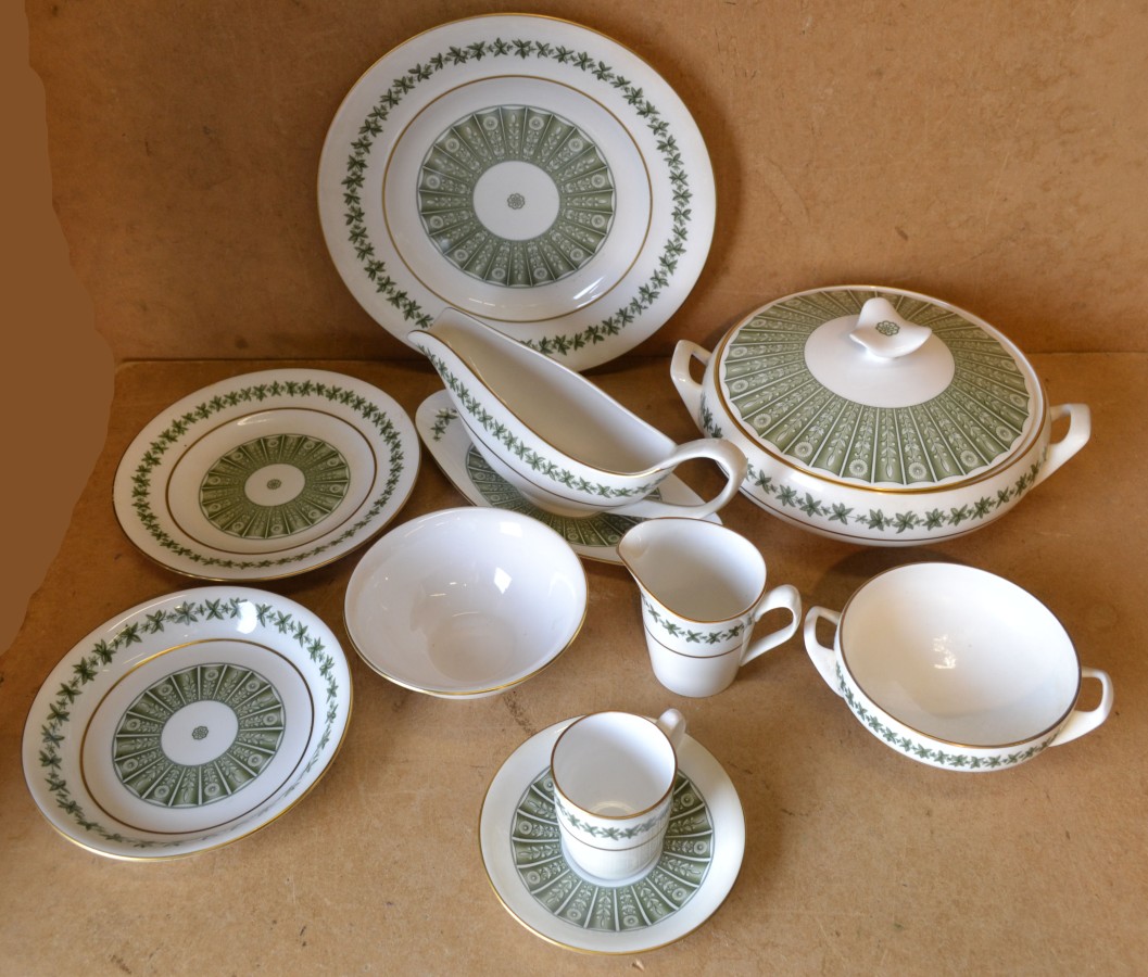 A Spode `Provence` Dinner Service Y7843 on white and green ground with gilt decoration, comprising