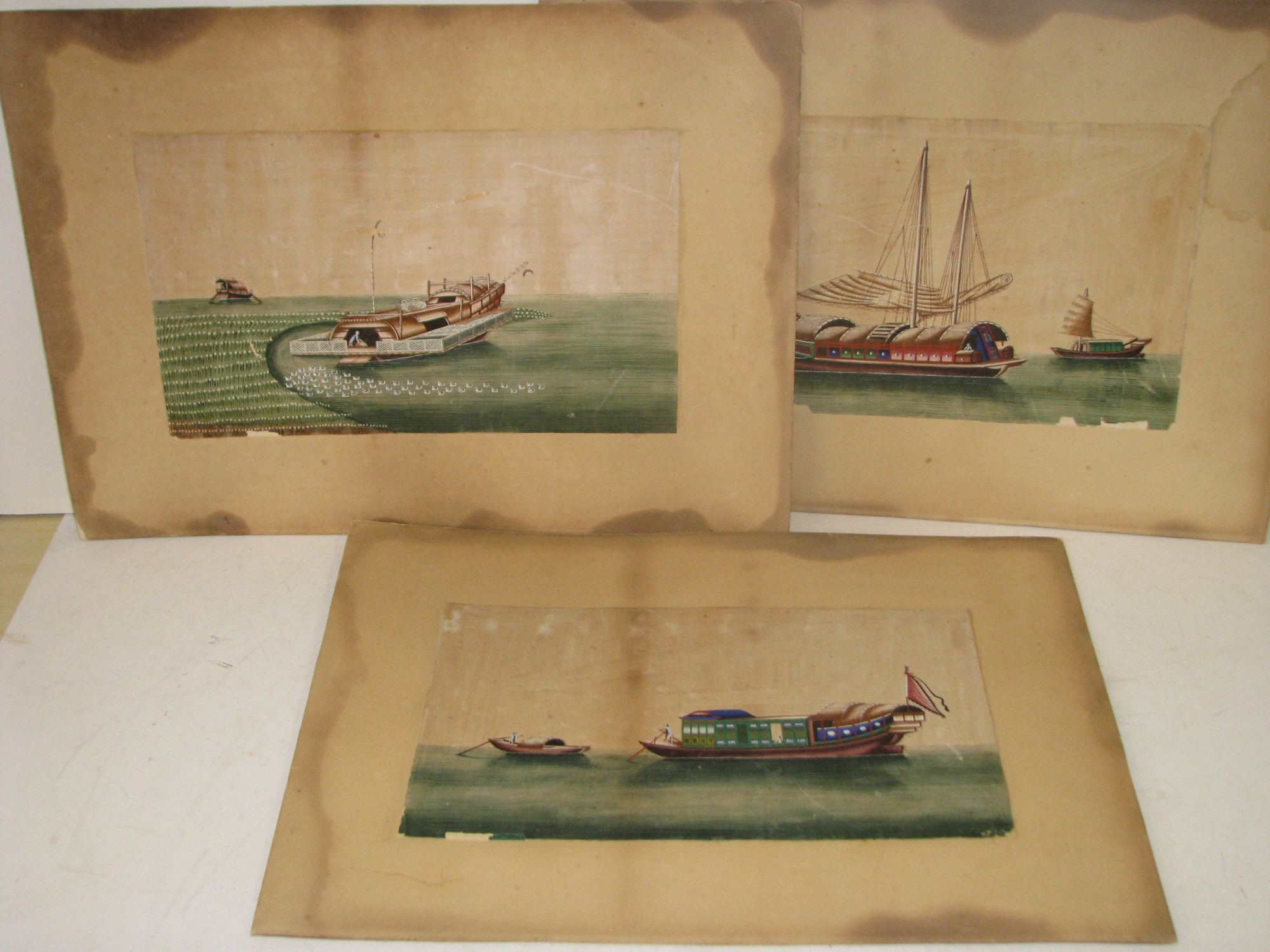 3 Oriental Rice Pictures depicting various boats, all mounted but unframed, 20cm x 33.5cm