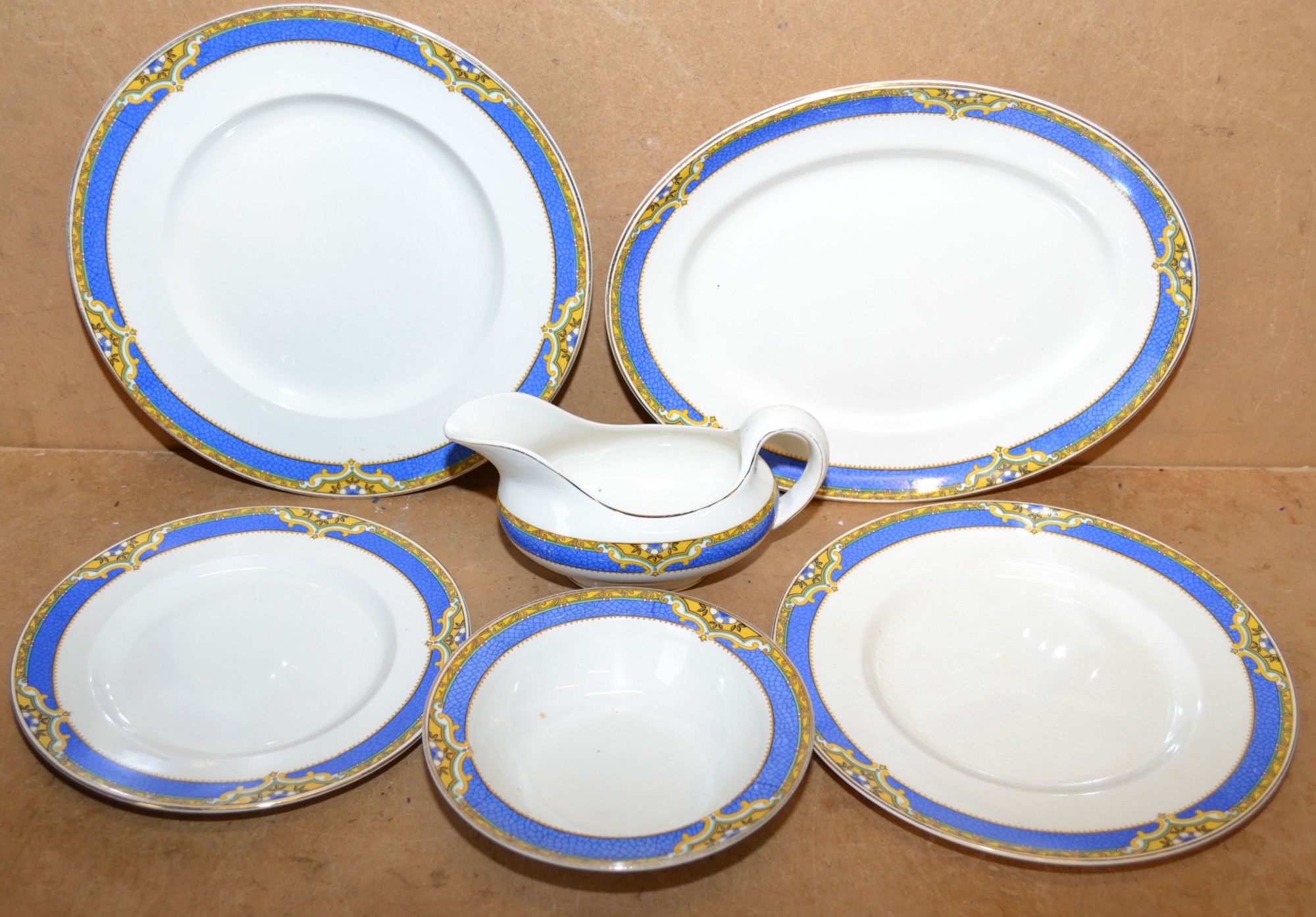 A Royal Staffordshire Pottery Part Dinner Service on white ground having blue and yellow floral