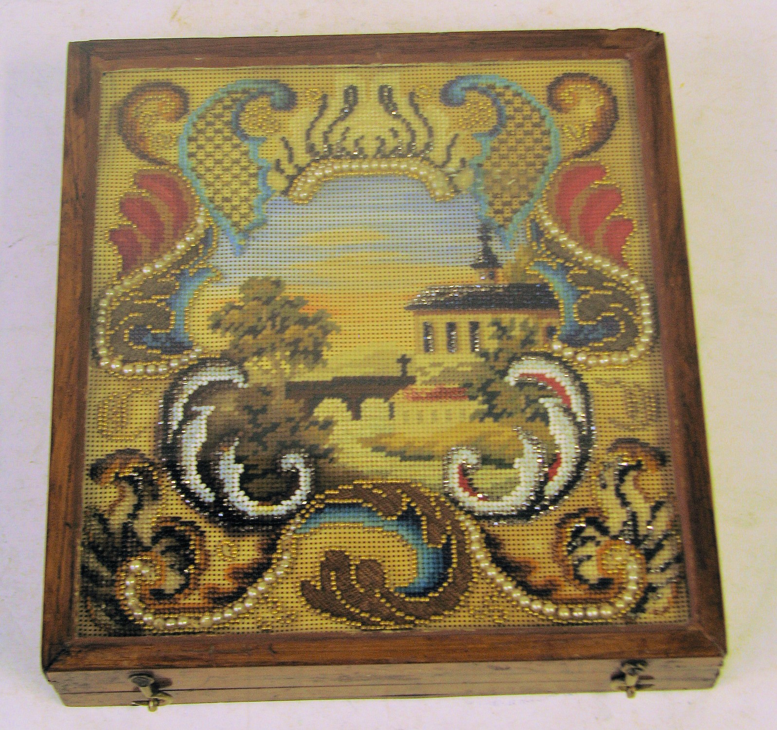 A Rectangular Box with hinged lid inset with tapestry depicting church, river and bridge, 18cm