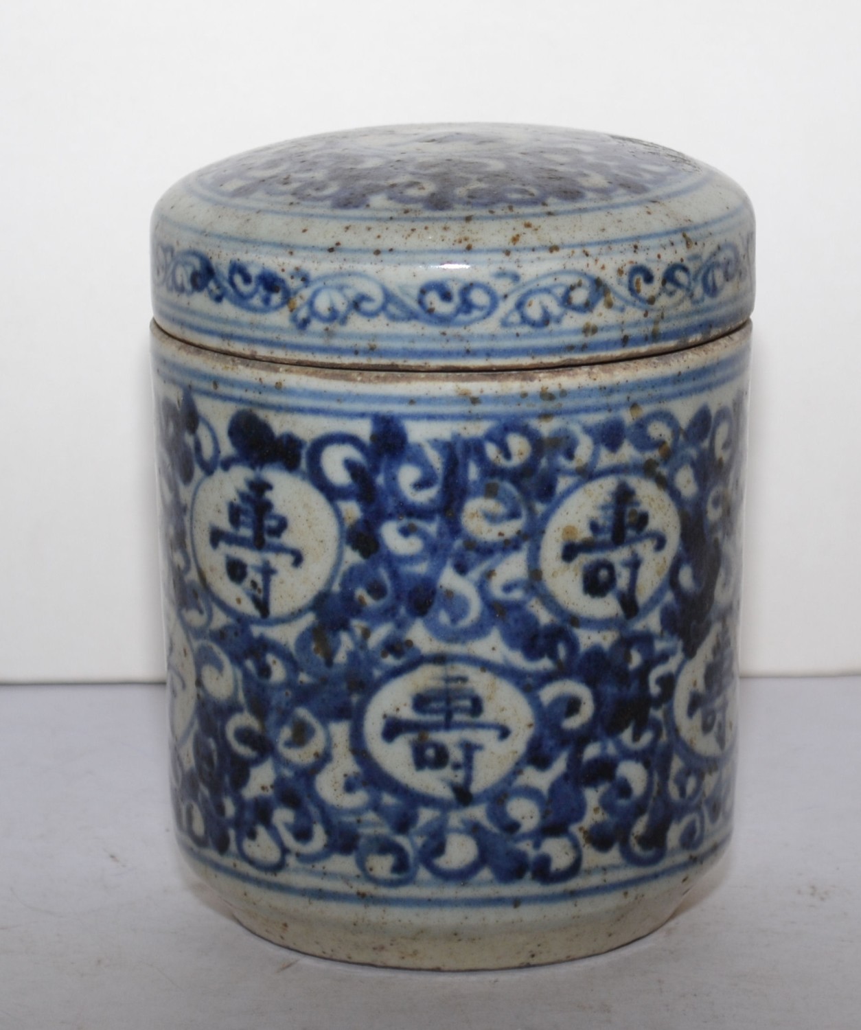 An Oriental Blue and White Lidded Pot with scroll and inscription decoration