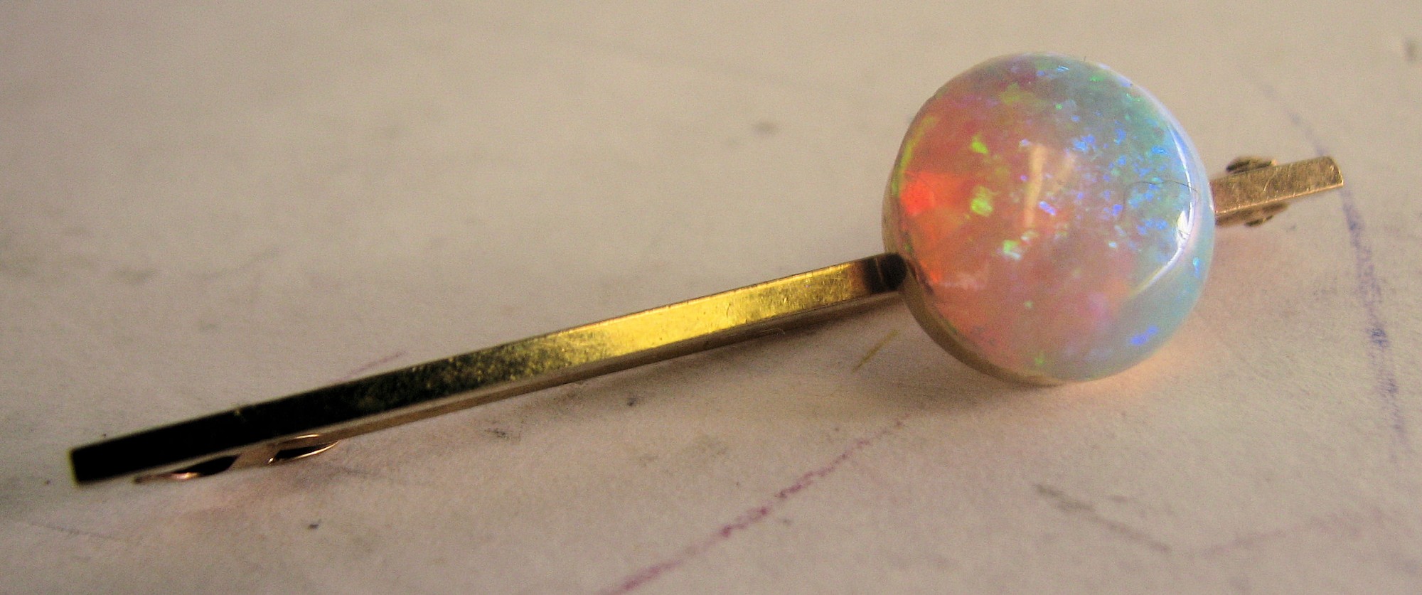 A Gold Bar Brooch mounted with opal