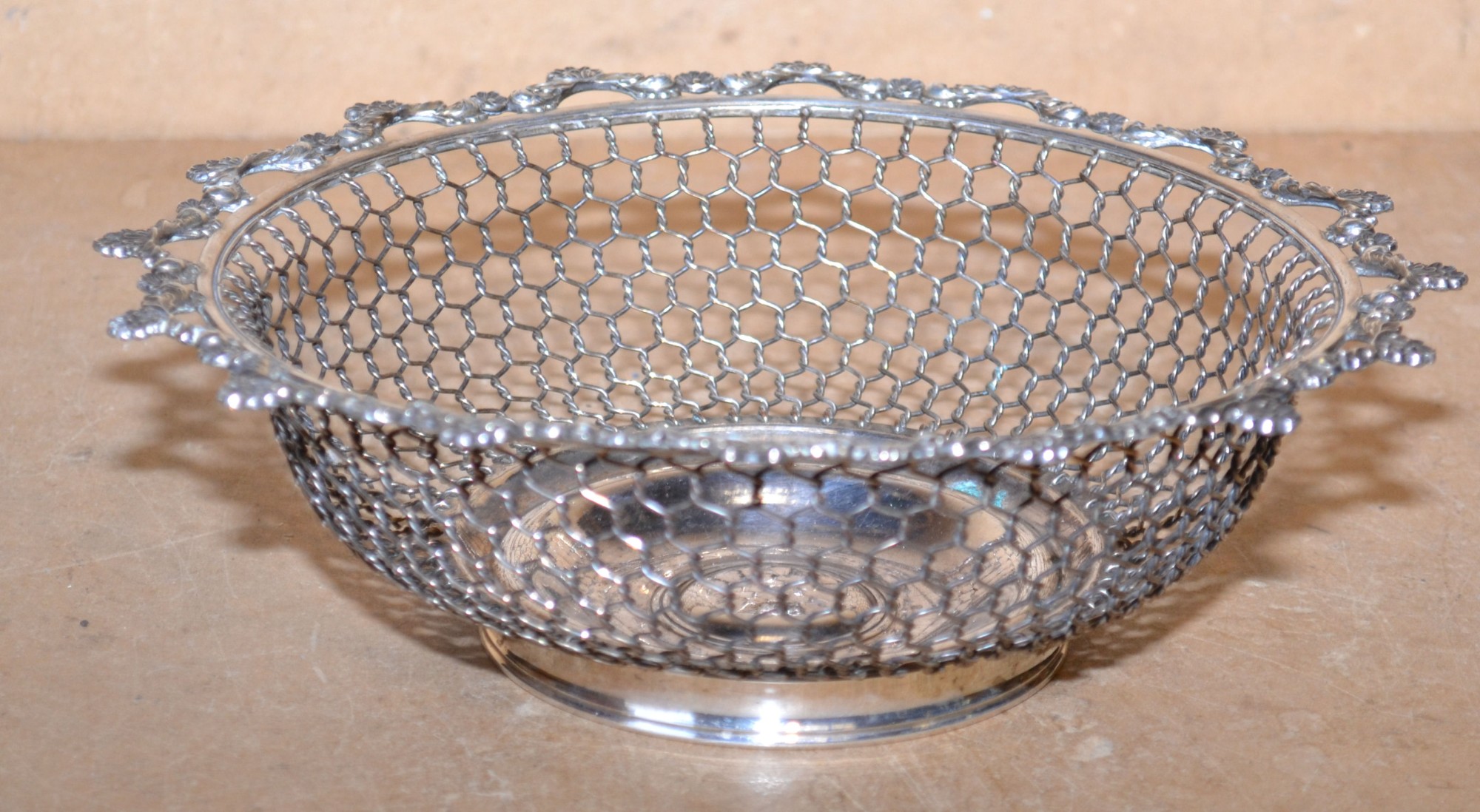 A Silver Plated Round Bread Basket having pierced shell and scroll rim, 23cm diameter