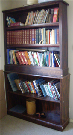 A pair of early 20th century oak free-standing bookcases, the rectangular beaded top above two