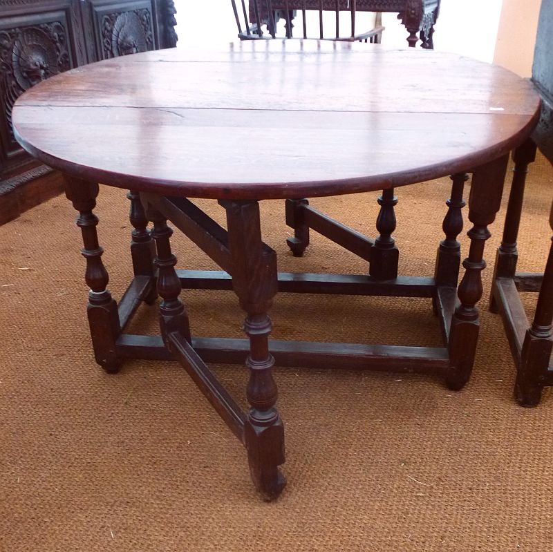 A late 17th/early 18th century oak gate-leg table, the oval top above a moulded frieze and raised on