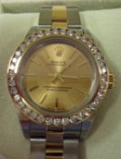 Ladies bi colour Rolex Oyster Perpetual wrist watch with champagne baton dial and diamond set bezel.