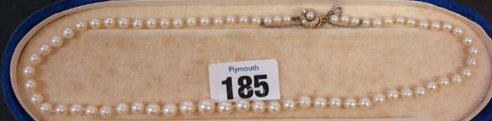 Row of cultured pearls with diamond and sapphire clasp