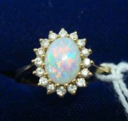 An opal and diamond cluster, set in 18ct yellow gold, size O