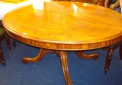 Victorian mahogany tip up top breakfast table the oval top upon a pedestal base with four scroll