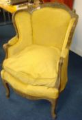 Upholstered armchair of French style with carved frame and cabriole legs
