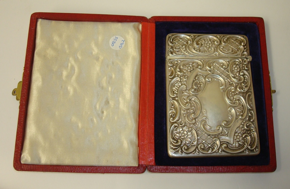 Silver card case with ornate scrollwork embossed decoration in original fitted red leathered case