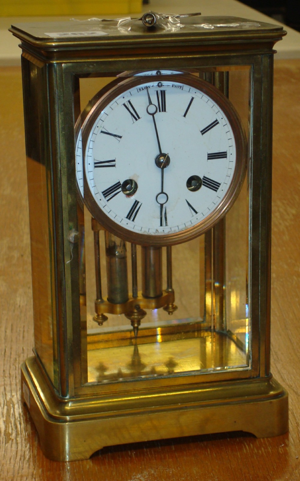 Brass four glass French clock with bell strike and mercury pendulum, with eight day movement with