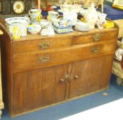 A heavy oak sideboard with gallery back fitted with three drawers and two cupboards t/w a