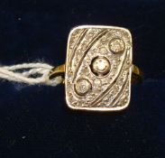 An 18ct yellow gold ring set with three old cut diamonds within a rectangular Art Deco pave style