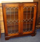 Small oak and leaded light two door free standing bookcase, 80cm wide x 98cm high