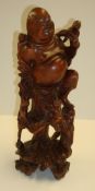 Oriental carved hardwood figure of a man surrounded by monkey`s, 30cm