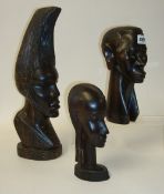 Three carved dark hardwood African busts, tallest 44cm