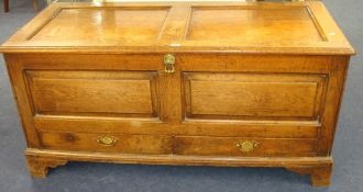 An antique oak chest fitted with two short drawers on bracket feet, 136cm wide