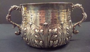 Carrington & Co, a 20th century silver porringer richly decorated in relief with acanthus leaves,