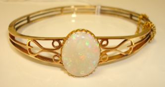 Antique 15ct gold and opal bangle, the central opal approx 17mm x 14mm, weighing approx 7.5ct, 15.