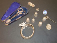 Various silver objects including thimbles, brooch, locket, bangle, silver scissor and thimble set in