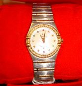 A Ladies Omega Constellation wrist watch with diamond set bezel and gemstone dot dial with stainless