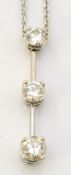 A 3 stone diamond pendant on a fine 9ct gold chain