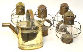 Group of four glass and copper storm lamps together with brass watering can (6 pints) (5)