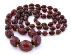 Red amber necklace with faceted beads, 63.3g, 48cm