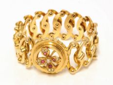 An 18ct yellow gold expandable bracelet set with a ruby and pearl, approx 16.6g