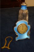 An enamel and silver easel table clock with 8 day movement (not working) together with a similar