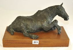 Pewter reclining horse on wooden base, 35cm long, 21 cm high