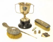 Silver trophy cup (damaged), two silver back dressing table items, two thimbles, fruit knife, button