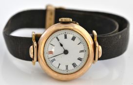An unusual 9ct gold reversible hunting wrist watch with gold mounted strap