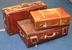 Three large traditional suitcases