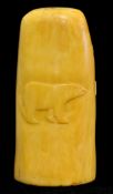 An Inuit carving of a marine ivory with scenes of a polar bear and a fish, 10cm high (Please visit